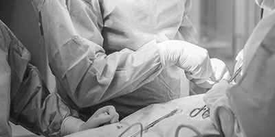 group of doctors performing surgery on patient