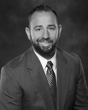 Headshot of Kourt Chatelain wearing a suit